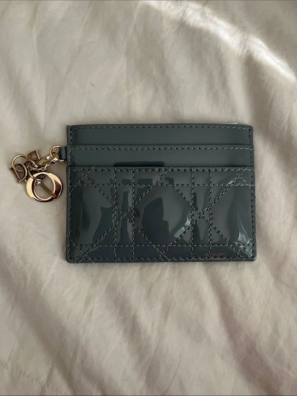Dior blue leather card holder with DIOR charm